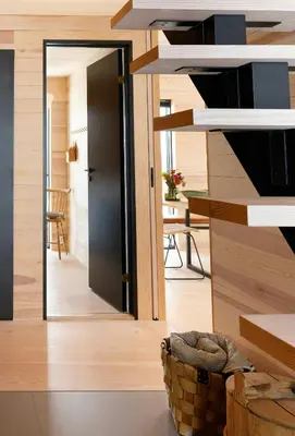 a room with a door leading to a kitchen with a table at Modern Light Neo Cabin On Bjefell in Svene