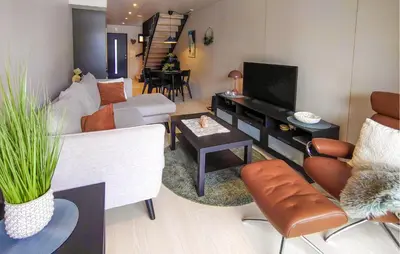 a living room with a couch and a tv at Amazing Apartment In Bjorli in Bjorli