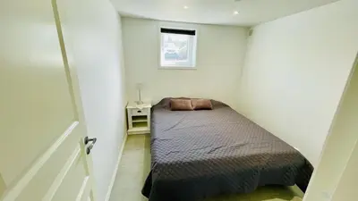 a small bedroom with a bed and a window at Cosy One Bedroom Apartment in Hval