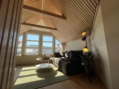 a living room with a couch and a table at Modern Apartment Vaskerelven 12 in Bergen