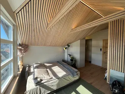 a bedroom with a bed with a wooden ceiling at Modern Apartment Vaskerelven 12 in Bergen