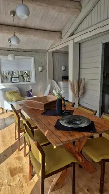 a dining room with a wooden table and chairs at Feriebolig Fannrem in Torshus