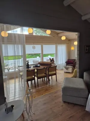 a living room with a table and a dining room at Feriebolig Fannrem in Torshus