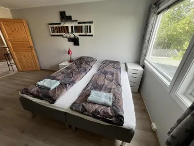 a bedroom with two beds and a window at Loft apartment with 3 bedrooms in Trondheim