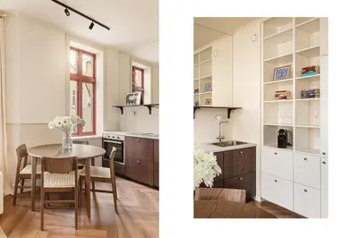 a kitchen with a table and a kitchen with white cabinets at F7 l Architects Choice in Bergen