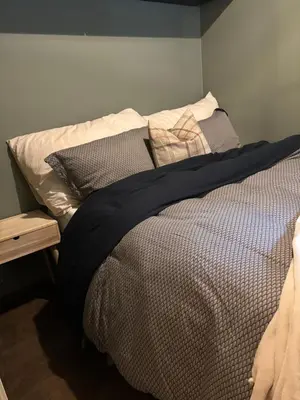 a bed with pillows on it in a bedroom at Røldal ski in ski out in Håra