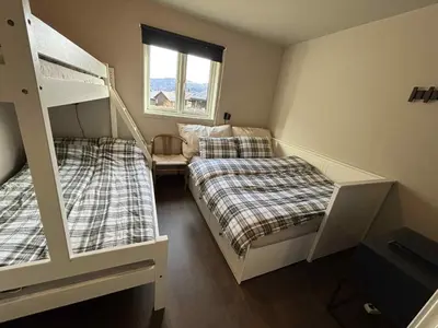 a bedroom with two bunk beds and a window at Røldal ski in ski out in Håra
