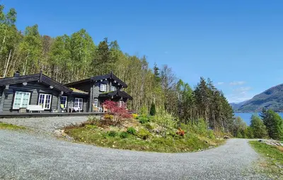 a house on a hill with a road in front of it at 4 Bedroom Stunning Home In Tørvikbygd in Tyrvikbygd