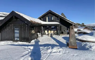 a log cabin in the snow with a swing at Pet Friendly Home In Hovden I Setesdal in Hovden