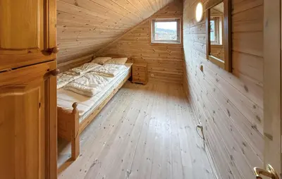 a bedroom with a bed in a wooden cabin at Pet Friendly Home In Hovden I Setesdal in Hovden