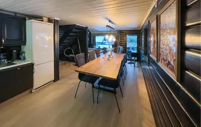 a kitchen and dining room with a wooden table and chairs at Pet Friendly Home In Hovden I Setesdal in Hovden