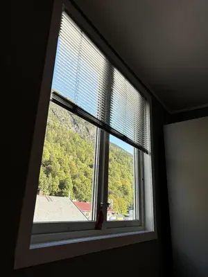 a window with a view of a mountain at Leilighet Rjukan sentrum in Rjukan
