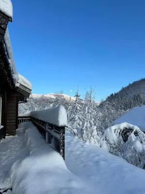 a bench covered in snow next to a house at Cozy cabin in Eikedalen in Eikedalen