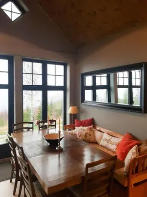 a living room with a wooden table and a couch at Private Cabin With Stunning Views Near Oslo in Eina