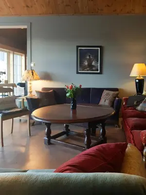 a living room with a couch and a table at Private Cabin With Stunning Views Near Oslo in Eina