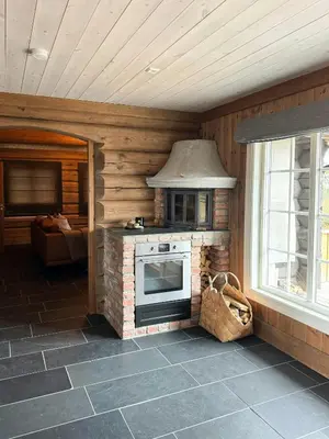 a kitchen with a brick oven in a cabin at Timber Cabin With Views Over Golsfjellet in Gol