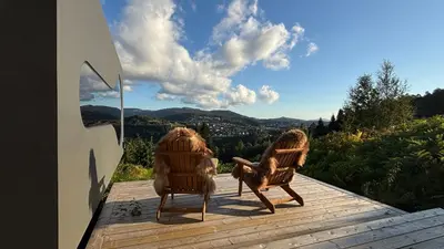two chairs sitting on top of a wooden deck at Birdbox Bergen in Bergen