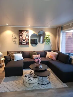 a living room with a couch and a table at Modern semi-detached house with free parking in Lillehammer