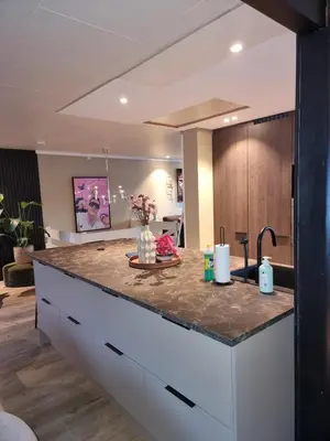 a kitchen with a large island with a counter top at Modern semi-detached house with free parking in Lillehammer