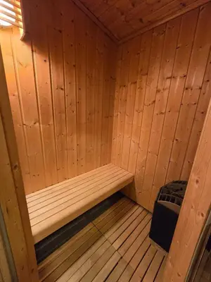 a wooden sauna with a bench in it at Adventurous cabin cozy on Sjusjøen with sauna! in Sjusjøen