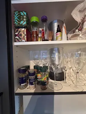 a cabinet with wine glasses and other items on it at Cabin at Norefjell! Perfect for families with children in Runn