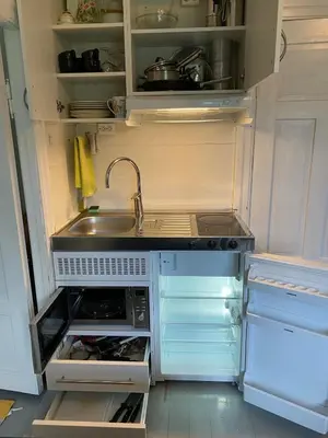 an empty kitchen with a sink and a refrigerator at Seaside apartment in farmhouse close to nature in Husevåg