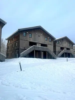 a large building with snow in front of it at Modern mountain apartmen Ski in and out in Trysil