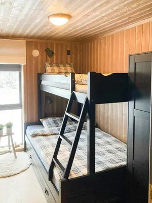 two bunk beds in a room with a ladder at Family Cabin With A View Of Skeikampen in Svingvoll