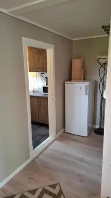 a kitchen with a white refrigerator in a room at Apartment in the heart of Sunnmore in Vigra