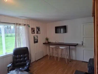 a room with a desk and a table and a chair at Apartment in the heart of Sunnmore in Vigra