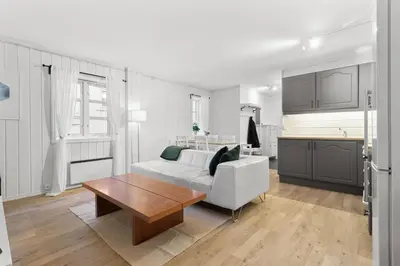 a living room with a white couch and a table at Staymate apartments. Trondheim sentrum in Trondheim