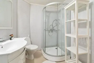a bathroom with a shower and a toilet and a sink at Staymate apartments. Trondheim sentrum in Trondheim