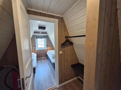 a small attic room with a staircase in a house at Fjellhytte i Valdres, rett ved nasjonalpark og turstier in Robøle