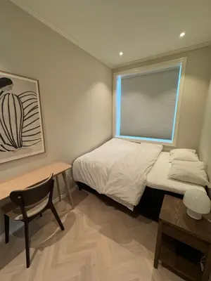 a small bedroom with a bed and a window at MB25 Apartment in Bergen