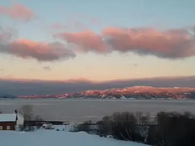 a view of a body of water with mountains in the background at Stort hus med havutsikt ved fjord og fjell med båt in Lensvik