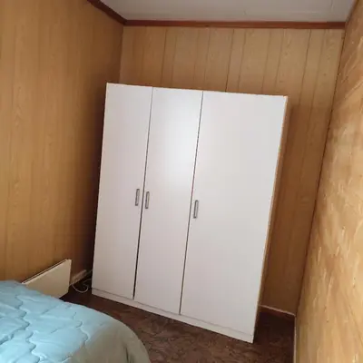 a bedroom with white cabinets and a bed at Leilighet nær E4 i sentrum av Eina in Eina