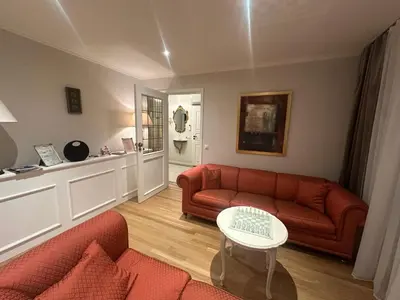 a living room with a red couch and a table at Magnhilds Luxury Apartment in Otta