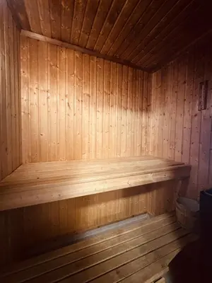 a wooden bench in a wooden sauna at Dream cabin by Geilo, ski-in ski-out with room for the whole family in Geilo