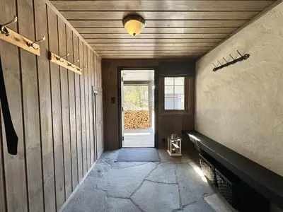 a hallway of a house with a door and a window at Dream cabin by Geilo, ski-in ski-out with room for the whole family in Geilo