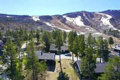 an aerial view of a house with a mountain at Dream cabin by Geilo, ski-in ski-out with room for the whole family in Geilo