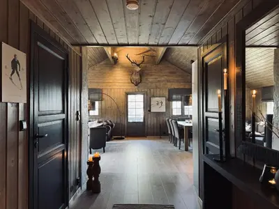 a hallway with a room with a dining room at Dream cabin by Geilo, ski-in ski-out with room for the whole family in Geilo