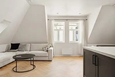 a white living room with a couch and a table at Bergen City Living in Bergen