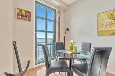 a dining room with a table and chairs and a window at Heimby - Seaside View Luxury - Free Parking in Bergen
