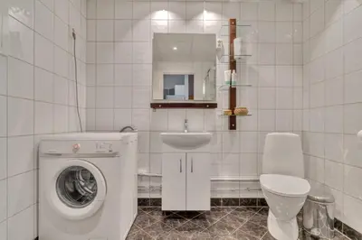 a bathroom with a washing machine and a sink at Heimby - Seaside View Luxury - Free Parking in Bergen