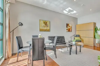 a living room with a table and chairs at Heimby - Seaside View Luxury - Free Parking in Bergen