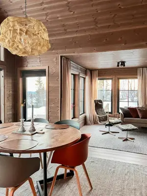 a living room with a table and chairs at Modern Family Cabin By Tempelseter Ski Trails in Eggedal