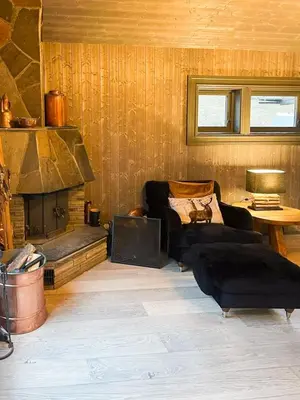 a living room with two couches and a fireplace at Mountain Escape Near Gulsrud With Historical Charm in Eggedal