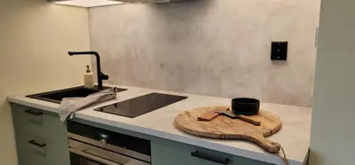 a kitchen with a wooden spoon and a cup on a counter at Morgensolen in Bergen