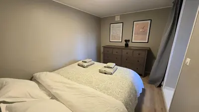 a bedroom with a bed with two towels on it at Morgensolen in Bergen