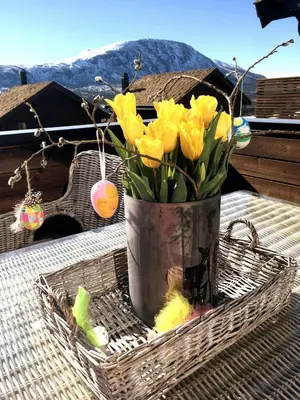 a vase of yellow flowers sitting on a table at Ski-in ski-out high standard cabin, 3 bedroom in Oppdal